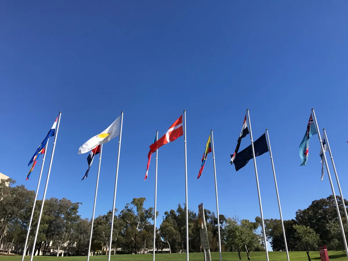Flags of many nations on tall poles against a blue sky at the International Flag Display.