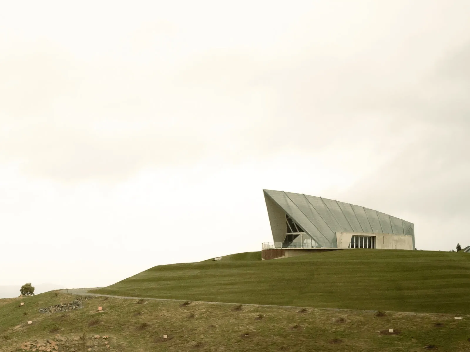 The Margaret Whitlam Pavilion on a grassy hill at the National Arboretum.