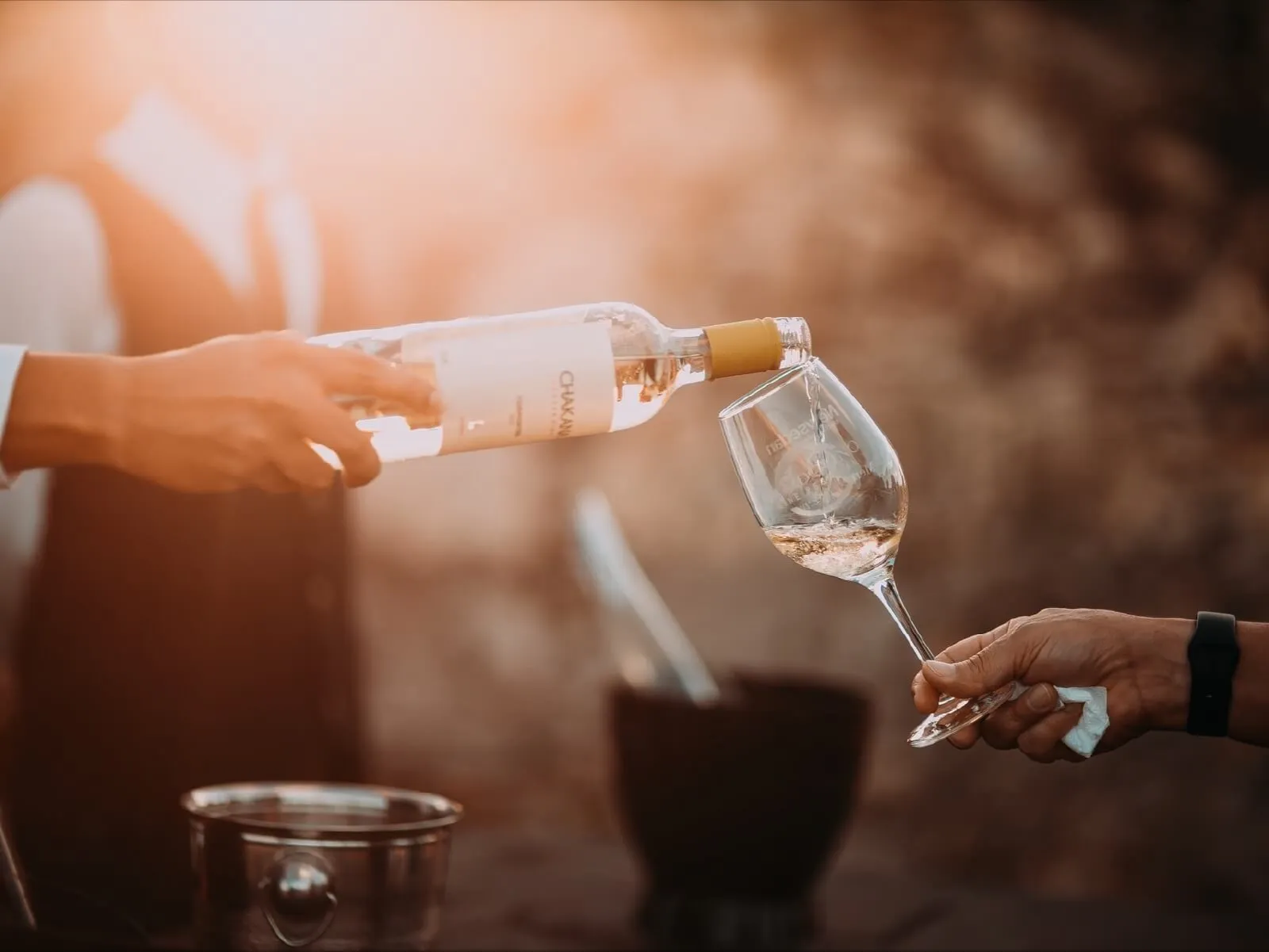 Rosé poured from a bottle into a wine glass.