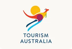 Stylised multicoloured kangaroo made from abstract shapes with a yellow sun behind it above the words TOURISM AUSTRALIA