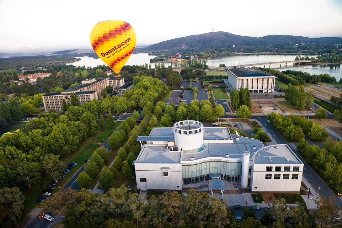 The Questacon hot air balloon above the Questacon building, with Lake Burley Griffin and Black Mountain behind.