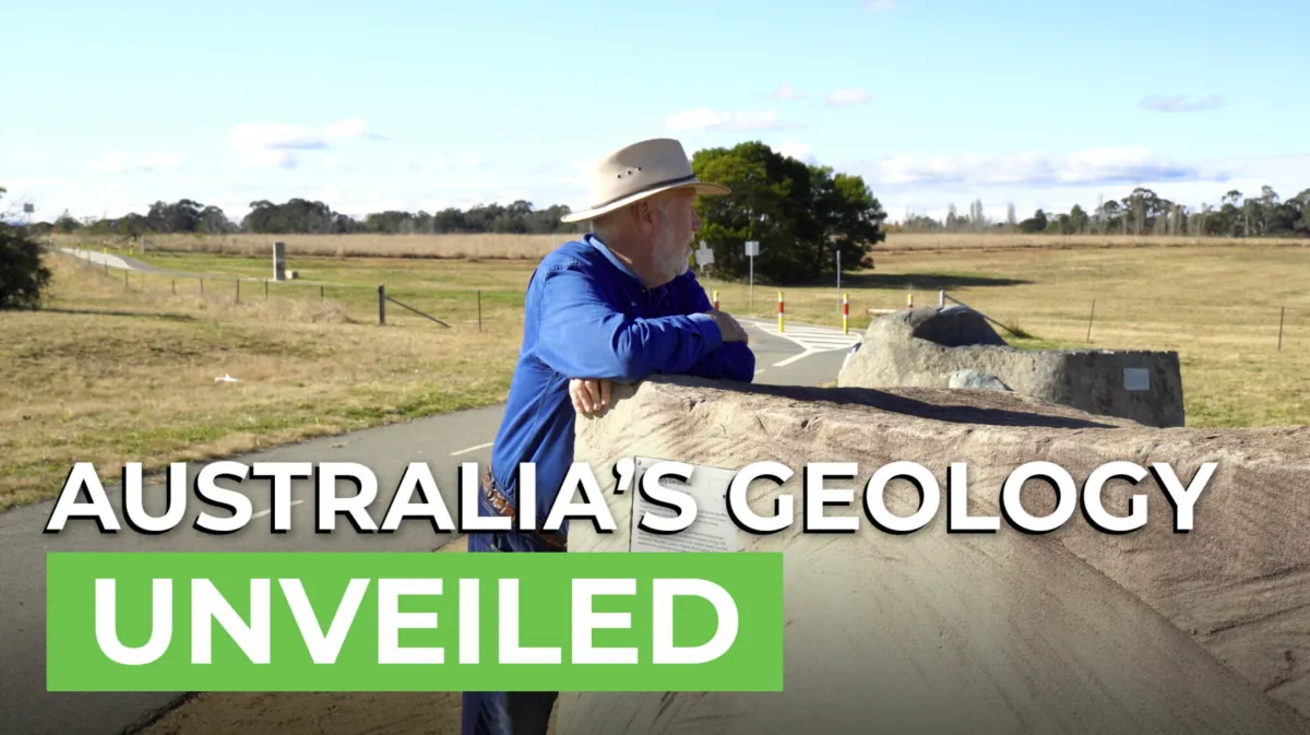 A guide in a hat leans on a large rock at the National Rock Garden, with the title Australia's Geology Unveiled.